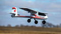 Model airplane with 'IteraScout' branding flying against a clear sky.